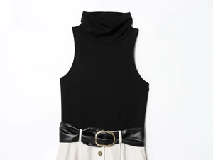 Detail of high neck sleeveless dress with black and beige panels and leather gold buckle belt