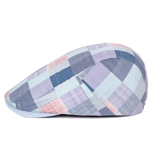 Detail of colorful plaid beret featuring light blue and purple woven fabric texture