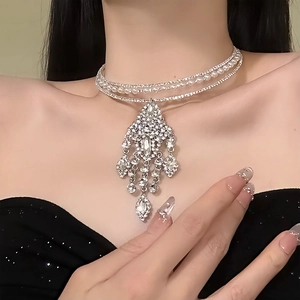 Detail of multi-layered choker necklace with sparkling rhinestones and pearl tassels