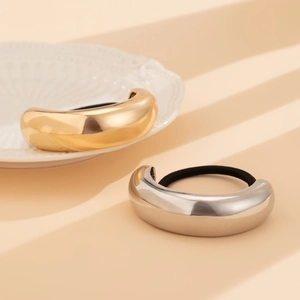 Close-up of gold and silver metallic double-layer curved hairbands with elastic ropes