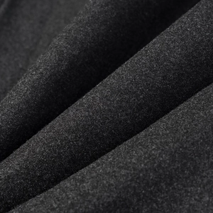 Macro shot of dark grey wool blend fabric showing detailed fiber texture and soft folds