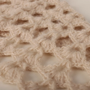 Beige mohair knit hat featuring intricate handmade crochet pattern for a trendy street look