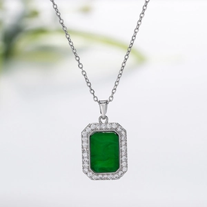 Macro shot of rectangular emerald stone necklace with a halo of white cubic zirconia