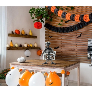 Detail of winged bird skeleton decoration in a festive Halloween party scene background