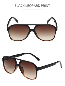 Detail view of black pilot sunglasses with leopard print and brown gradient lenses