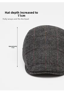 Detail view of dark grey herringbone tweed flat cap with a depth of 11cm for men