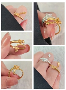 Detailed close-up of dragon ring with scale texture, red gemstone eyes and leaf charm
