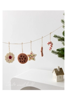 Felt wool Christmas tree ornaments with star and candy cane hanging on rustic jute twine