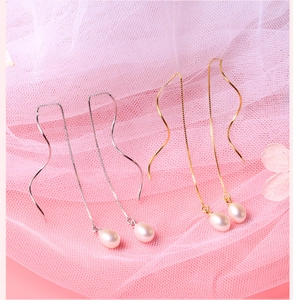 Detailed view of S925 silver pearl drop earrings in gold and silver finish with lace
