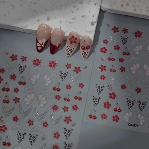 Detail of 5D red flower and cherry nail stickers with leopard patterns on finished nails