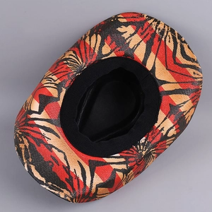 Vintage western cowboy hat with red and yellow abstract print shown in top-down view