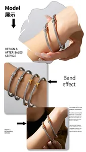 Detail of twisted cable cuff bracelet with X-shaped metal accents and bicolor finish