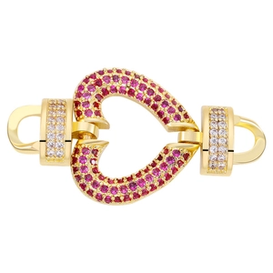 Detailed view of a gold heart-shaped connector with red and clear zircon stones