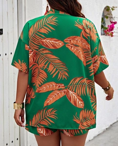 Detail of tropical palm print on green summer two-piece shirt and shorts set