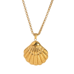 Close-up of a glossy gold shell pendant on a dainty stainless steel O-chain necklace