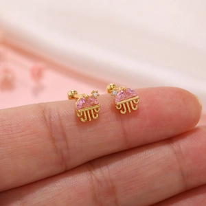 Close-up of golden jellyfish stud earrings with pink crystals and screw ball backs