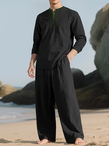 Detail of black linen beach set featuring long sleeve Henley top and relaxed trousers