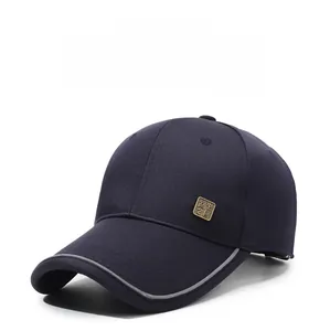 Detail of dark blue baseball cap with reflective brim edge and vintage metal badge