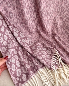 Detailed macro view of pink leopard jacquard scarf with soft texture and beige fringe trim