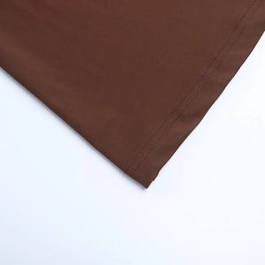 Gros plan détaillé du tissu marron foncé montrant la couture précise à double aiguille
