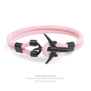 Detailed view of pink milan line braided bracelet with black aircraft pendant clasp