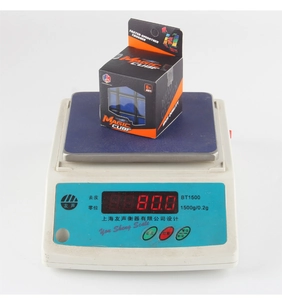 Close-up of a 5.7cm 3x3 educational magic cube on an electronic scale weighing 80.0g