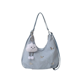 Light blue crossbody bag with pleated fabric, metal butterfly, and white cloud charm