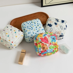 Quilted floral sanitary napkin storage bags in four patterns on a white background