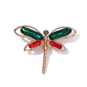 Close-up of a gold-plated dragonfly brooch with vibrant red and green crystal wings