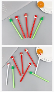 Close-up of festive Christmas gel pens with tree, hat, and snowman silicone toppers