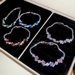 Close-up of five colorful zircon geometric oval bracelets in a luxury velvet jewelry box
