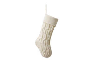 Close-up of cream cable knit Christmas stocking with braided texture and hanging loop