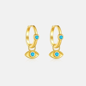 Detail of S925 sterling silver hoop earrings with gold evil eye charms and blue stones