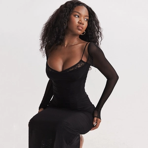 Close-up of black bodycon dress with lace trim neckline and sheer mesh long sleeves
