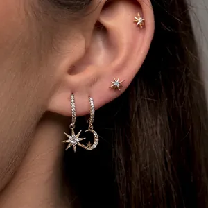 Elegant gold celestial earring set with star and moon drops featuring sparkling crystals