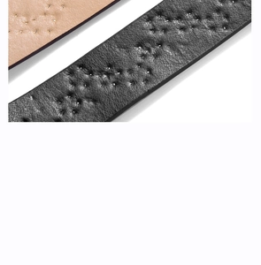 Detail of star-studded punk leather belts in beige and black with hole punch accents