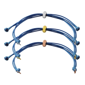Detailed view of three blue braided rope bracelets with gold, silver and rose gold beads