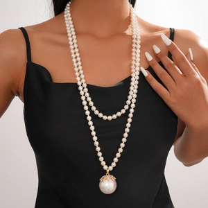 Detail of double-layer baroque pearl necklace with gold rhinestone pendant decoration