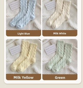 Detailed cable knit texture of thick thermal winter socks in pastel candy colors