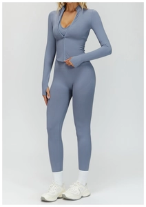 Three-piece gray-blue ribbed yoga set with zip jacket, sports bra, and high-waist leggings