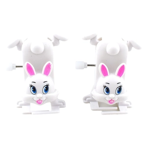 Close-up of a pair of white wind-up rabbits with pink ears and mechanical clockwork keys