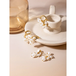 18K gold plated stainless steel grape-shaped earrings with white pearls on a minimalist background