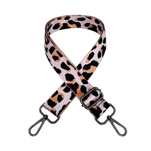 Close-up of leopard print nylon bag strap with dark gunmetal swivel hooks and slider