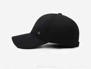 Detailed side view of black winter baseball cap featuring warm wool-like texture and metal logo
