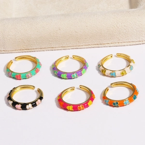 Detailed set of six gold-plated enamel flower rings in vibrant assorted colors