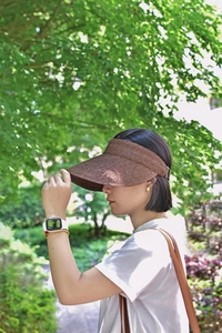 Detail of high-density raffia sun visor showing woven texture and adjustable back closure