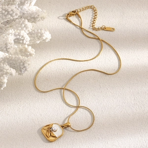 Detail of 18K gold plated square pendant with white shell, butterfly and pearl accent
