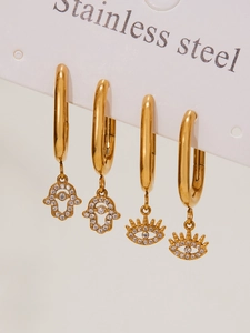 Detail of 18k gold plated Hamsa hand and Evil Eye earrings set with sparkling zircons
