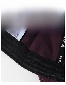 Macro shot of the black sweatband and internal stitching details on a burgundy cotton cap