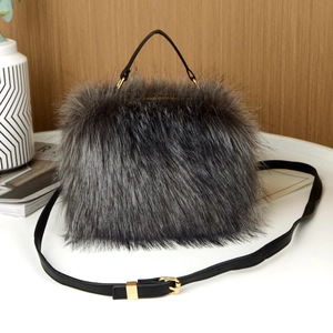 Detailed view of the dark grey faux fur handbag with black leather handle and gold hardware